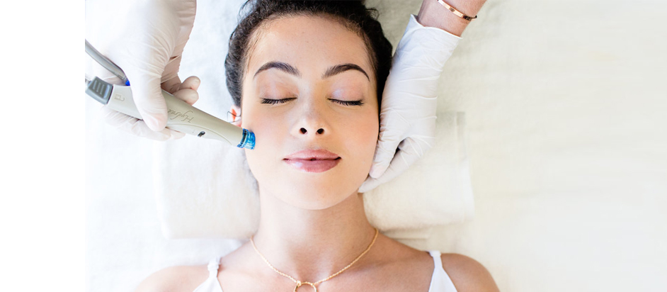 A close-up of a HydraFacial treatment being performed, showcasing glowing and rejuvenated skin.